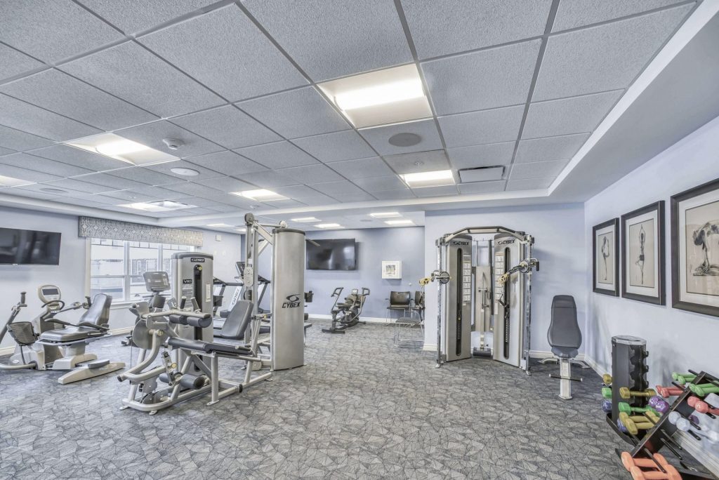 Spacious indoor gym with various modern exercise machines and equipment.