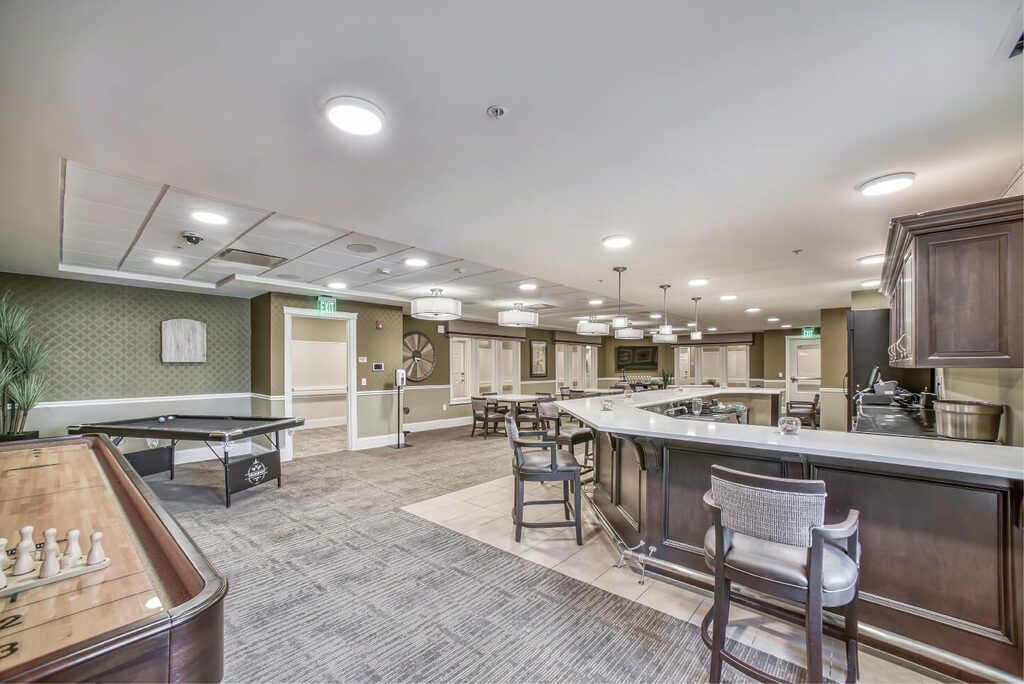 bright community bar and community game room at Rose Senior Living