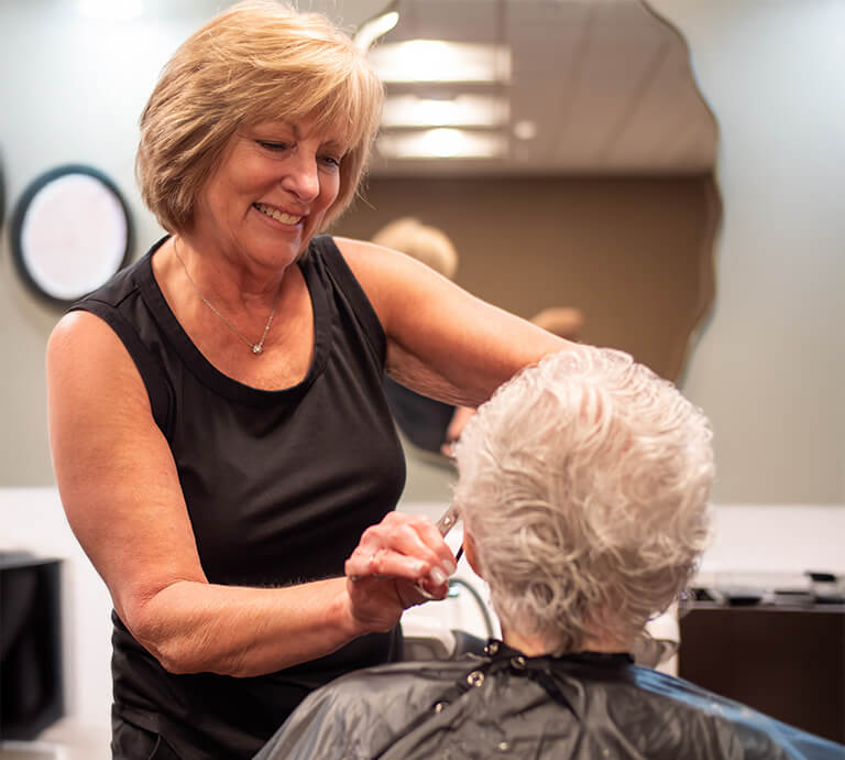 Senior woman getting her hair cut at the Beachwood Salon